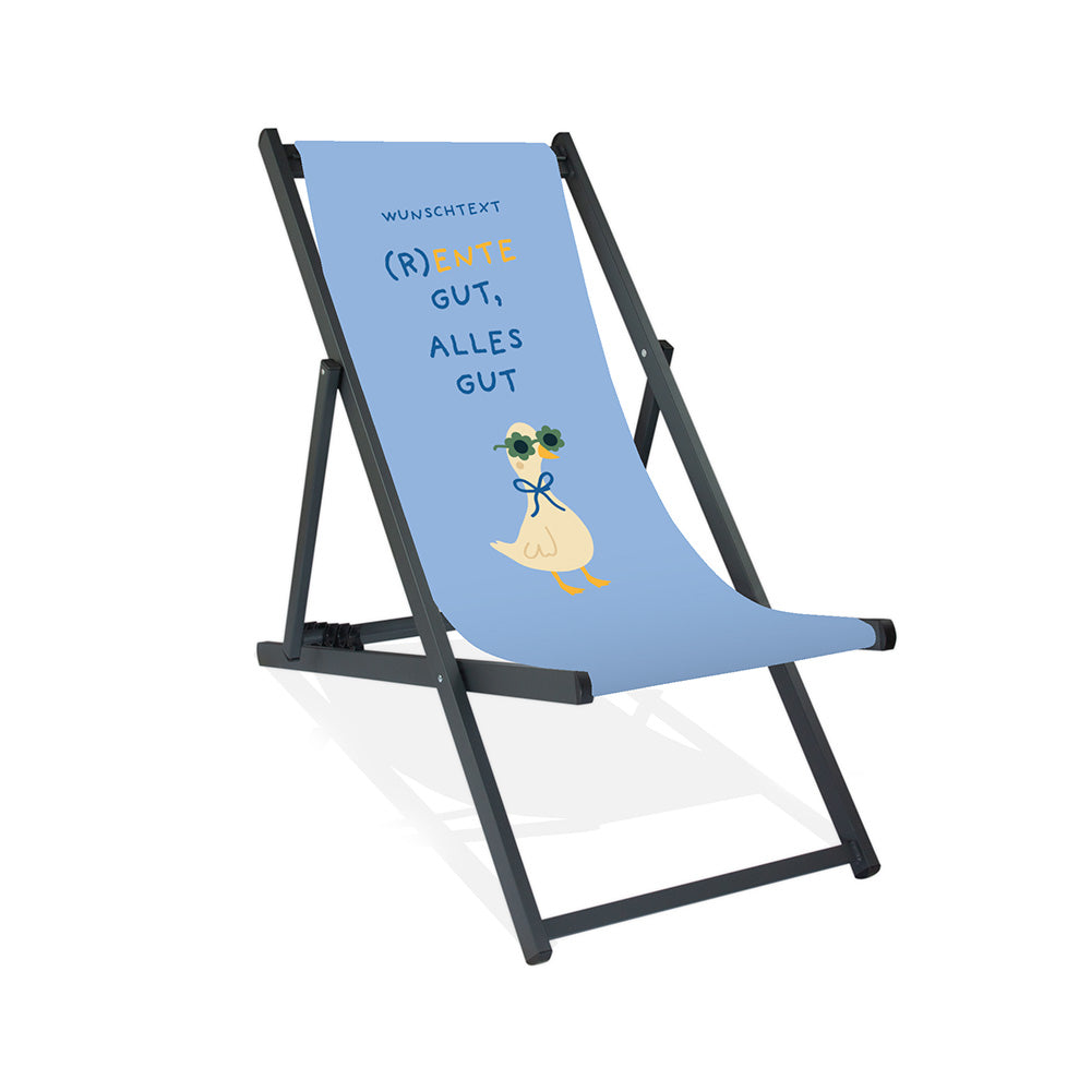 Mockup eines personalisierten Aluminiumliegestuhls ohne Armlehne mit himmelblauen Hintergrund, Enten-Motiv mit Sonnenbrille und Schriftzug "(R)Ente gut, alles gut."
Die Farbe des Liegestuhls ist Schwarz.