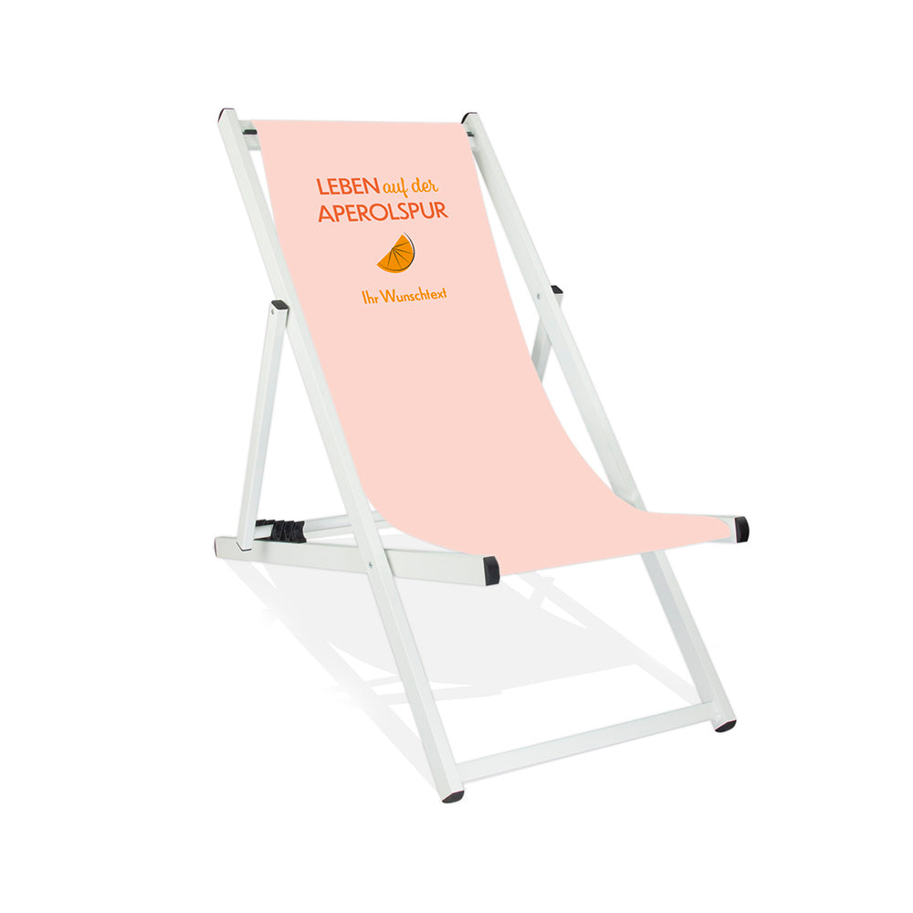 Mittig ist ein weißer Alumiumliegestuhl ohne Armlehne abgebildet.
Helles Motiv mit dem Spruch "Leben auf der Aperolspur". 