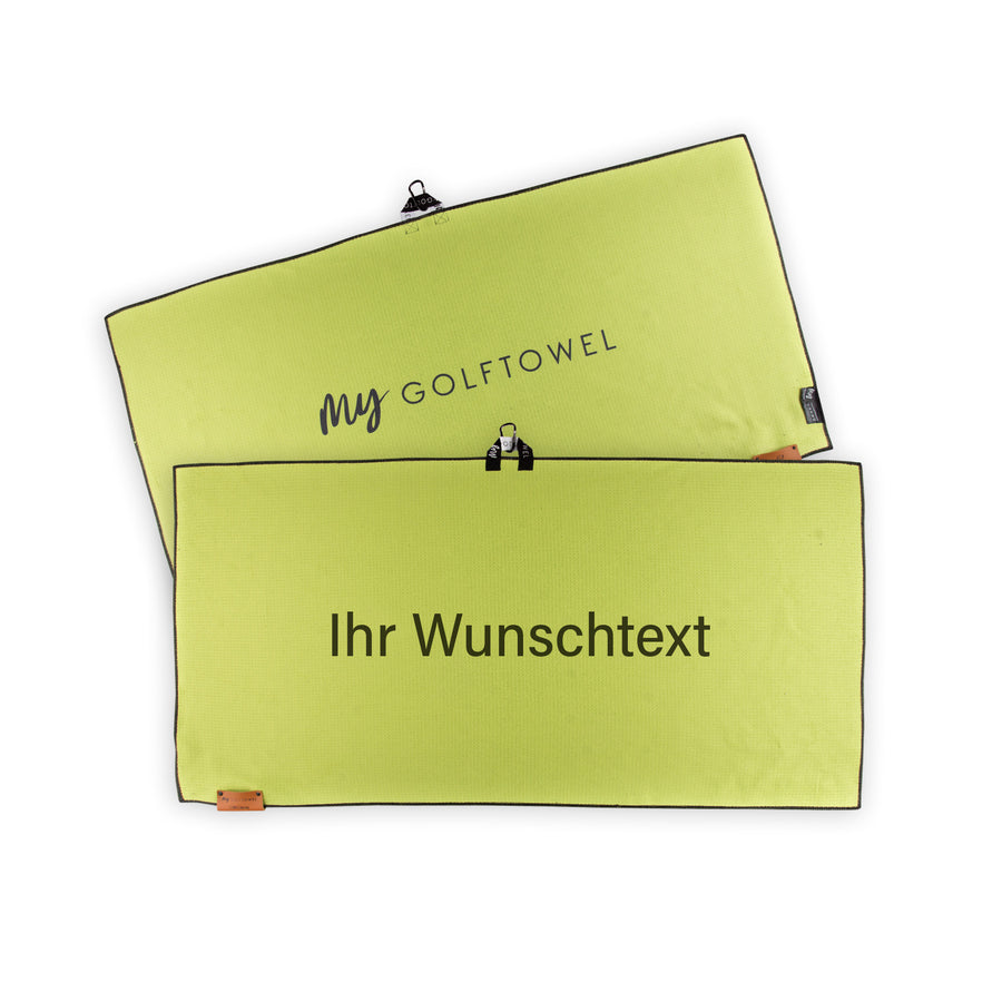 Golftowel Large in Lemon. Auf dem Golftowel steht Mittig in einer schwarzen, serifenlosen Schrift geschrieben "Ihr Wunschtext". Die Rückseite des Golftowels ist im gleichen Farbton, wie die Vorderseite dargestellt. Hier steht mittig der Schriftzug "MyGolftowel". Im unteren Bereich befindet sich ein braunes Lederpatch und oben ist eine Schlaufe und Karabiner angebracht.